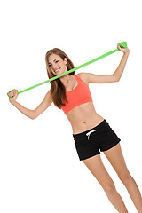 Image showing athletic young woman doing workout with physio tape latex tape