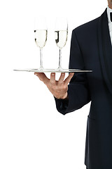 Image showing adult male waiter serving two glass of champagne isolated