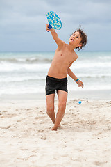 Image showing happy little child kid boy  playing beachball on beach in summer 