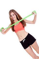 Image showing athletic young woman doing workout with physio tape latex tape