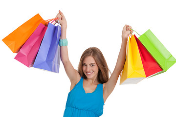 Image showing attractive young woman with colorful shopping bags isolated