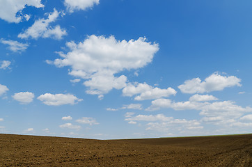 Image showing cloudy sky over black field