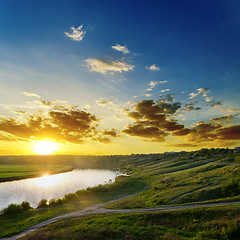 Image showing sun over river with dramatic sky