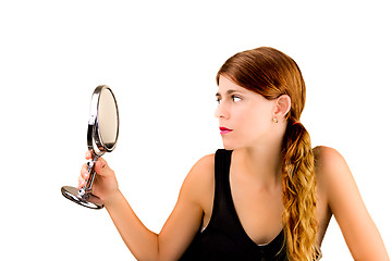 Image showing Checking herself in the mirror