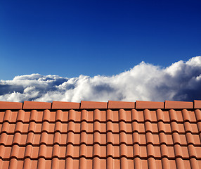 Image showing Roof tiles and sunny sky with clouds