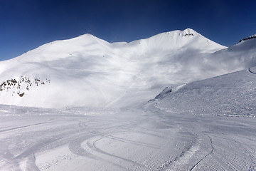 Image showing Ski slope with snowmobile trail