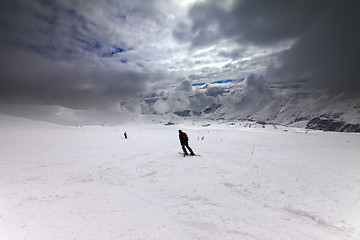 Image showing Skiers on ski slope before storm