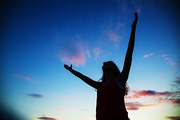 Image showing Woman staying with raised hands