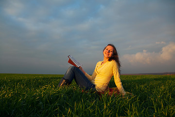 Image showing Teen girl reading book outdoors