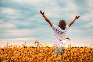 Image showing Young man staying with raised hands