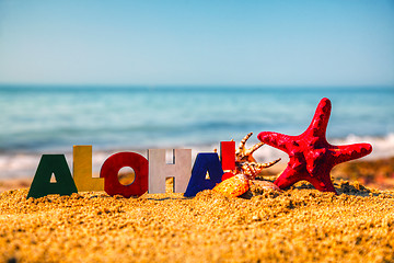 Image showing Wooden colorful word 'Aloha' on the sand