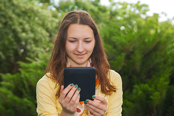 Image showing Teen girl reading electronic book