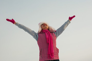 Image showing Teen girl staying with raised hands