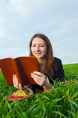 Image showing Teen girl reading the Bible outdoors