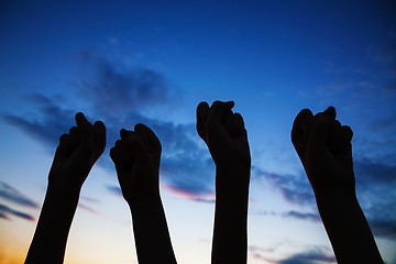 Image showing Four raised clenched fists