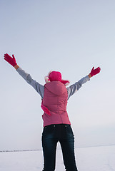 Image showing Teen girl staying with raised hands