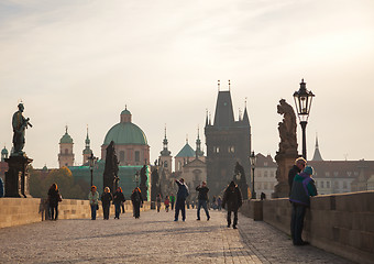 Image showing Charles bridge early in the morning with tourists 