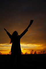 Image showing Woman staying with raised hands