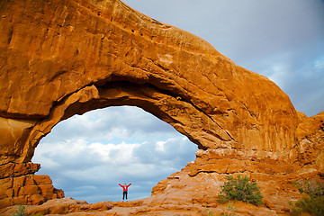 Image showing Woman staying with raised hands inside an Arch