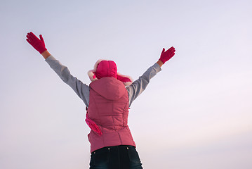 Image showing Teen girl staying with raised hands