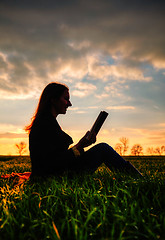 Image showing Teen girl reading book outdoors