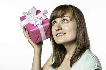 Image showing young girl listens to a gift