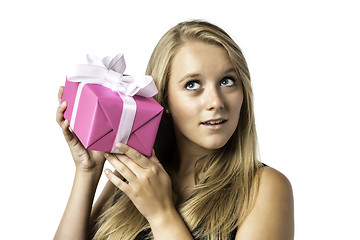 Image showing Young blond girl listens to a gift