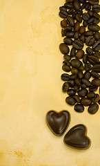 Image showing Two heart shaped chocolate candies and coffee beans