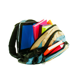 Image showing Backpack with colorful books and tablet PC against white backgro