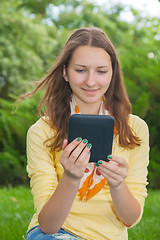 Image showing Teen girl reading electronic book