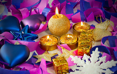 Image showing Christmas decorations and candles over blue background