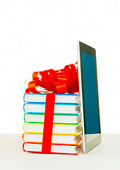 Image showing Books tied up with ribbon and tablet PC against white background