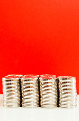 Image showing Coins stacked in bars against red background