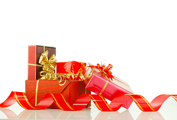 Image showing Christmas presents in red boxes against white background