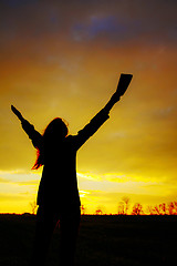 Image showing Woman staying with raised hands