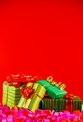 Image showing Wrapped boxes with presents against red background