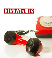 Image showing Red old fashioned telephone - Contact us concept