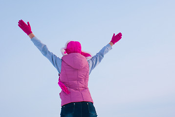 Image showing Teen girl staying with raised hands