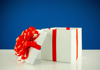 Image showing White box with present against blue background
