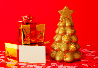 Image showing Two presents, blank card and golden evergreen tree