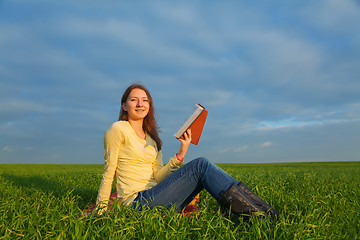 Image showing Teen girl reading the Bible outdoors