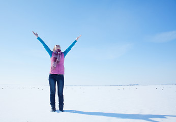 Image showing Teen girl staying with raised hands