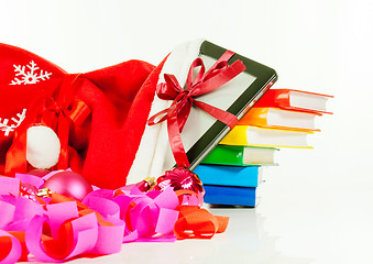 Image showing Electronic book reader with stack of books in bag against white background