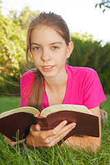 Image showing Teen girl reading the Bible outdoors