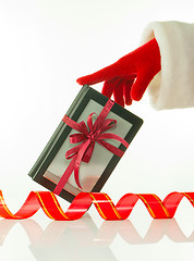 Image showing Hand in red glove holds electronic book reader against white background