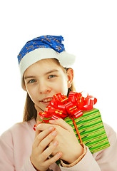 Image showing Teen girl wearing Santa hat with a present against white backgro