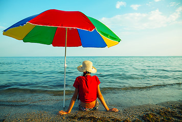 Image showing Teen girl seating at a beach