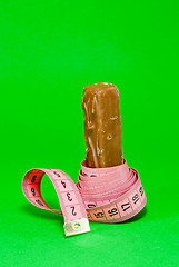 Image showing Chocolate bar with a pink metering tape