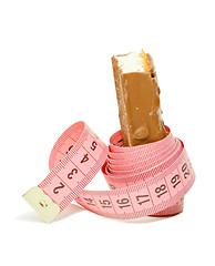 Image showing Chocolate bar with a pink metering tape