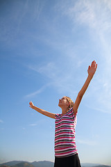 Image showing Teenage girl staying with raised hands